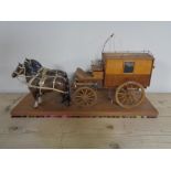 A hand built wooden cart with two china horses on stand