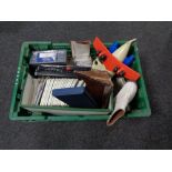 A crate of cribbage board, vintage ice skates, etc,