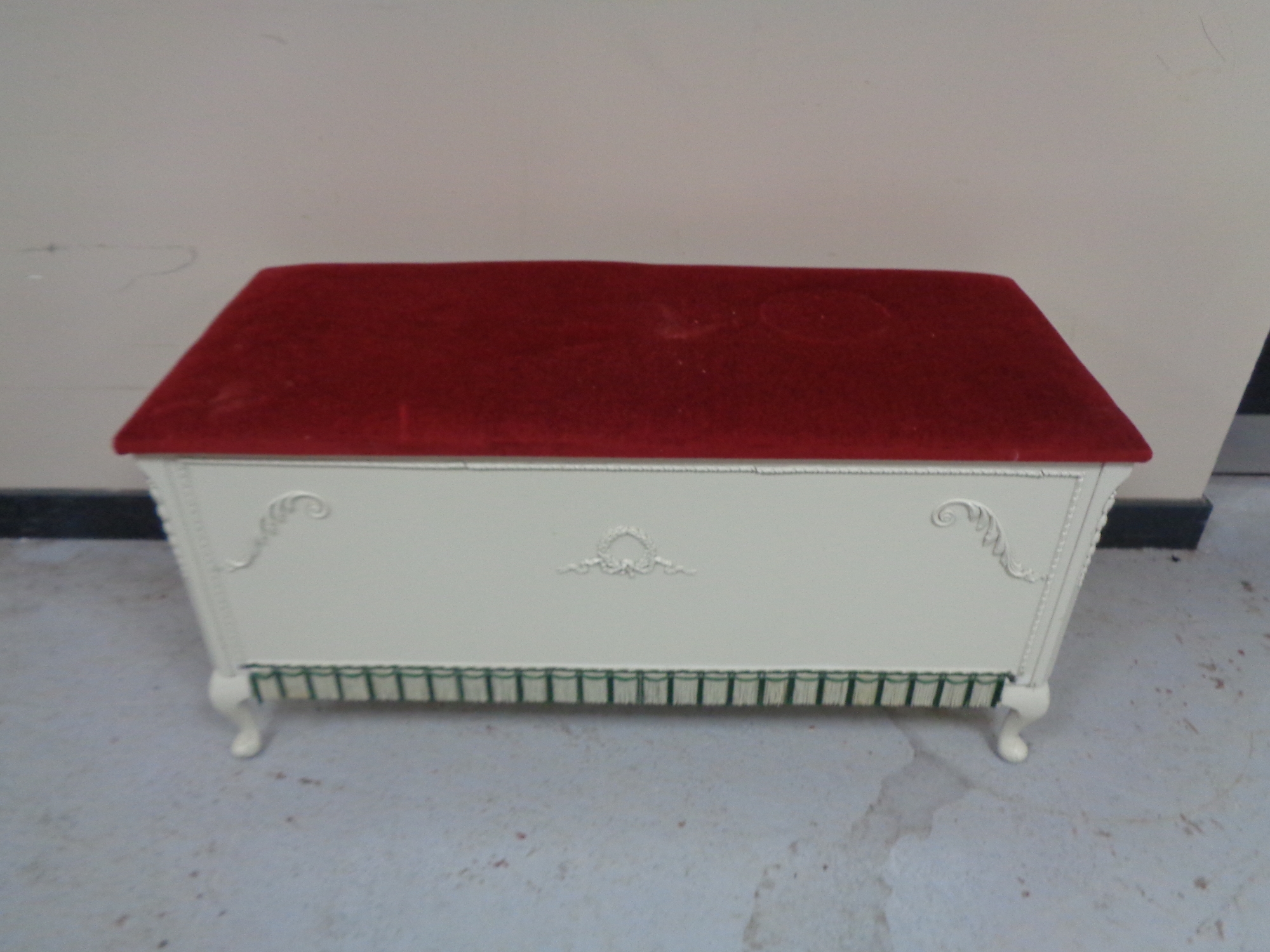 A blanket box with red dralon seat