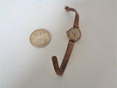 A Victorian 1890 silver Crown together with a 9ct gold lady's wristwatch on brown leather strap