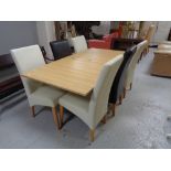 A contemporary oak effect extending dining table together with six high backed leather chairs (four