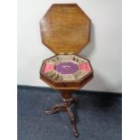 A Victorian walnut pedestal work table