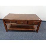 A contemporary two tier coffee table fitted three drawers