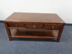 A contemporary two tier coffee table fitted three drawers