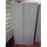 A metal double door stationary cupboard