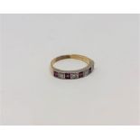 A ruby and diamond half eternity ring, 18CT size O.