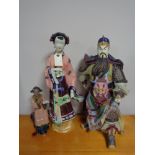 A large Japanese warrior figure and two oriental style figures