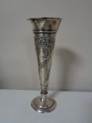 A slender silver spill vase