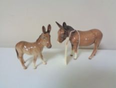 Two Beswick donkey foals.