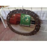 An Edwardian carved oak framed mirror