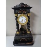 An ebonised and painted mantel clock with brass and enamelled dial on wooden base with pendulum and