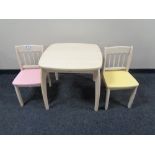 A child's dining table and two chairs