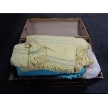 An antique wooden bound domed top trunk containing bedding and blankets