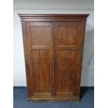 An antique pine double door school cupboard