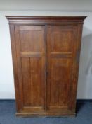 An antique pine double door school cupboard