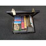 A leather briefcase containing first day cover stamps,