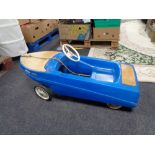 A 20th century child's plastic pedal car in the form of a boat