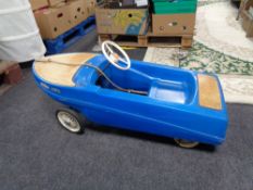 A 20th century child's plastic pedal car in the form of a boat