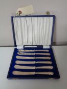 A cased set of six silver handled butter knives,