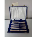 A cased set of six silver handled butter knives,