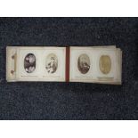 A Victorian leather embossed photograph album containing monochrome photographs