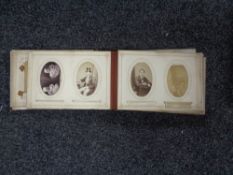 A Victorian leather embossed photograph album containing monochrome photographs