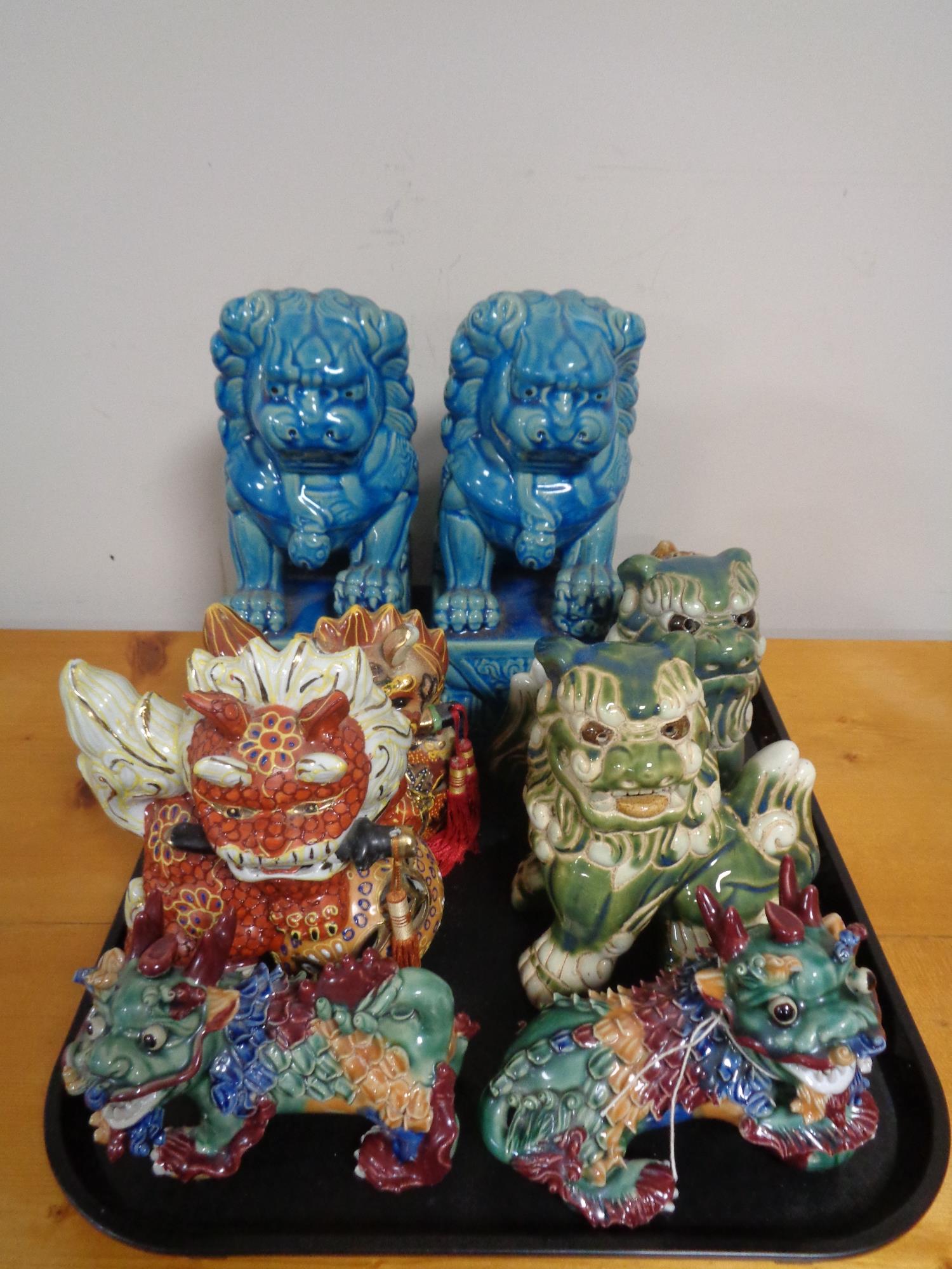 A tray of decorative Chinese dog figures