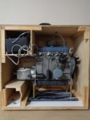A scratch built plastic model of a combustion engine in wooden crate