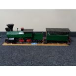 A hand built wooden model of a steam train with carriage