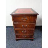 A reproduction mahogany two drawer filing chest with inset leather panel