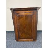 A Georgian oak corner cabinet with astragal glazed door