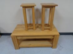 An oak coffee table and pair of matching plant stands