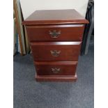 A mahogany effect three drawer chest