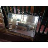 A metal framed bevelled mirror