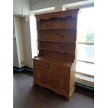 A pine triple door kitchen dresser fitted with two drawers