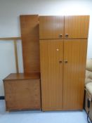 A teak effect double door wardrobe with top cupboard together with a twentieth century teak