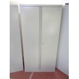 A metal double door stationary cupboard