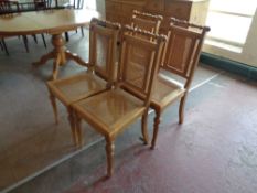 A set of four pine begere upholstered dining chairs
