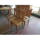 A set of four pine begere upholstered dining chairs