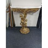 A marble topped gilt wood hall table on cherub support base