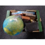 A box of miscellany including wooden candlesticks, 20th century globe, gent's travel set,