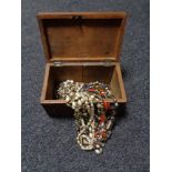 An antique inlaid wooden jewellery casket containing beads, necklaces,