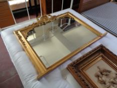 A gilt framed Victorian style overmantel mirror