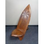 A carved hardwood fertility chair