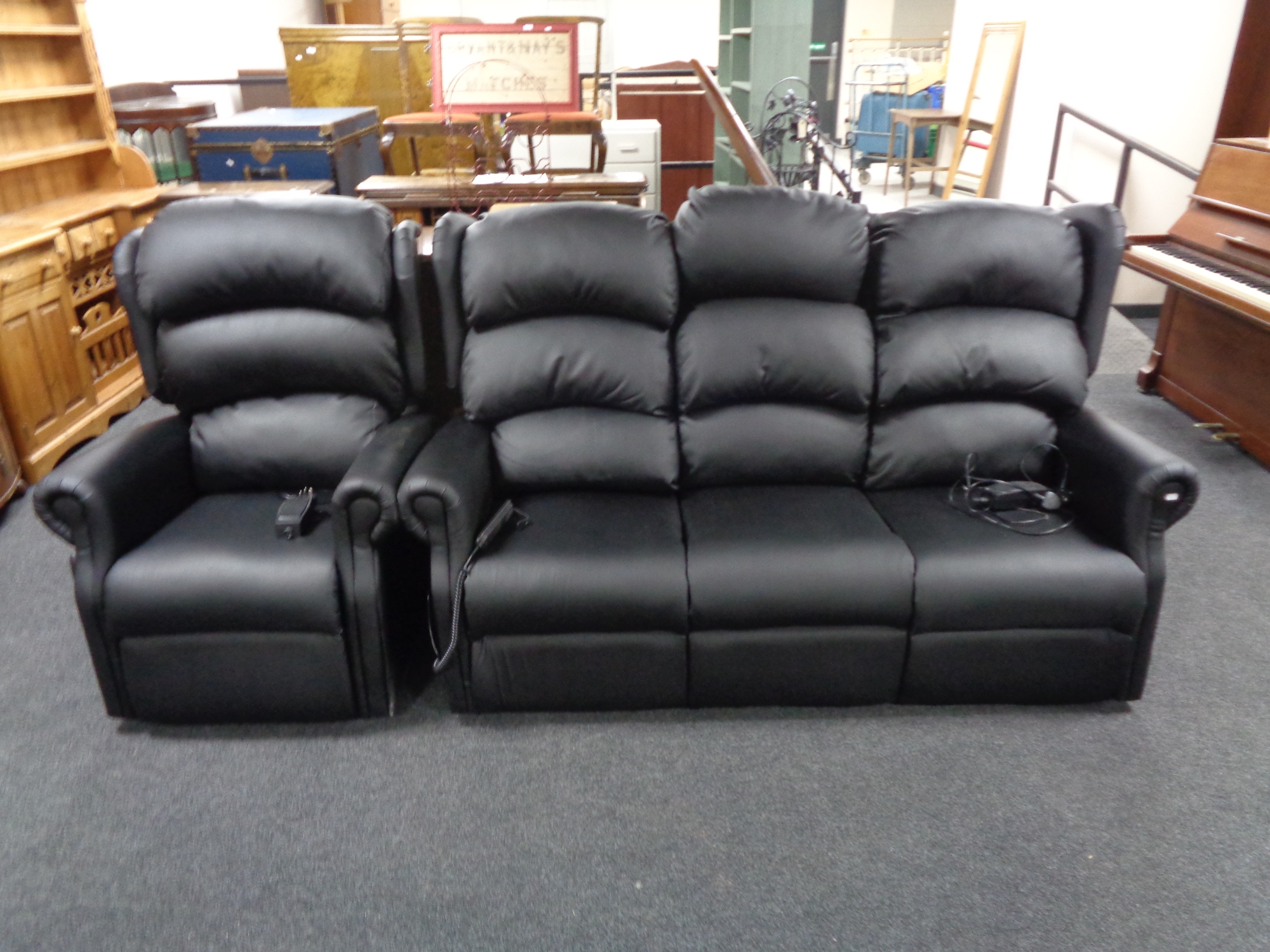 A black leather three seater electric reclining settee and matching armchair (Vendor has receipts
