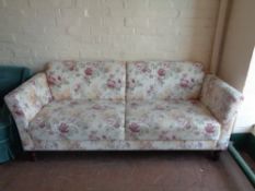 A twentieth century settee upholstered in a floral fabric