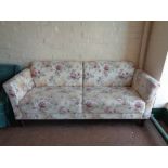 A twentieth century settee upholstered in a floral fabric