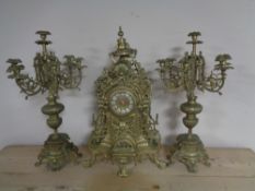A continental gilt three piece clock garniture