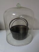 An antique glass bell jar cover and two antique jam pans