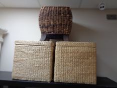 A pair of wicker storage stools and a further wicker stool